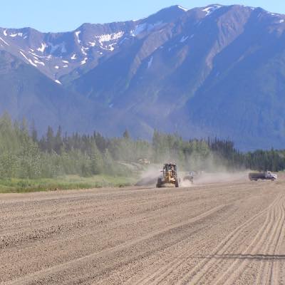 Construction on runway in Canada with mountains in background