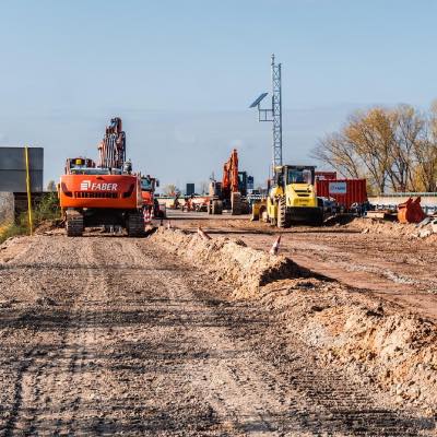 Road construction site with construction vehicles working