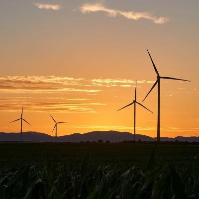 Wind farm turbines at sunset
